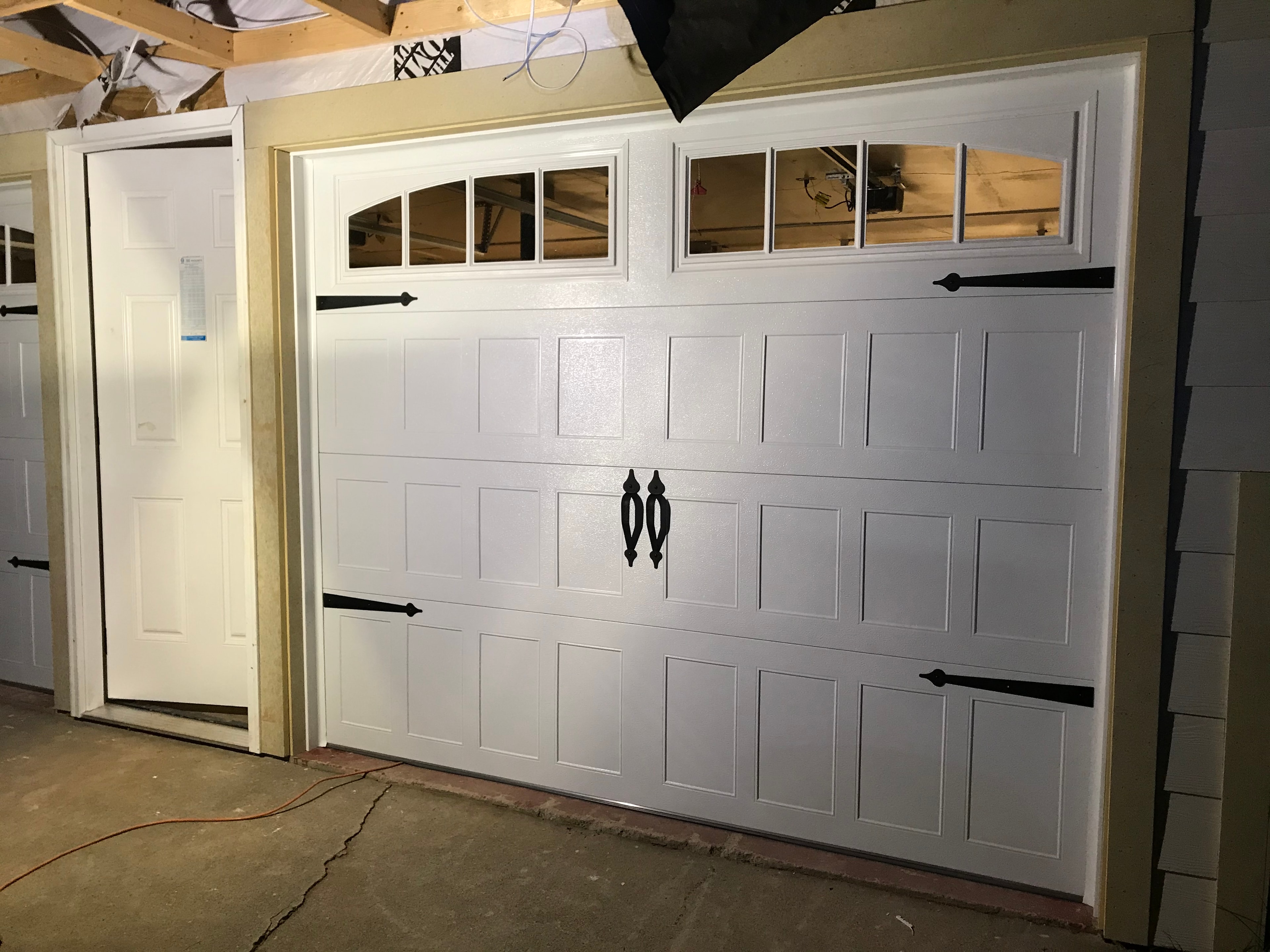White garage door with windows and hardware