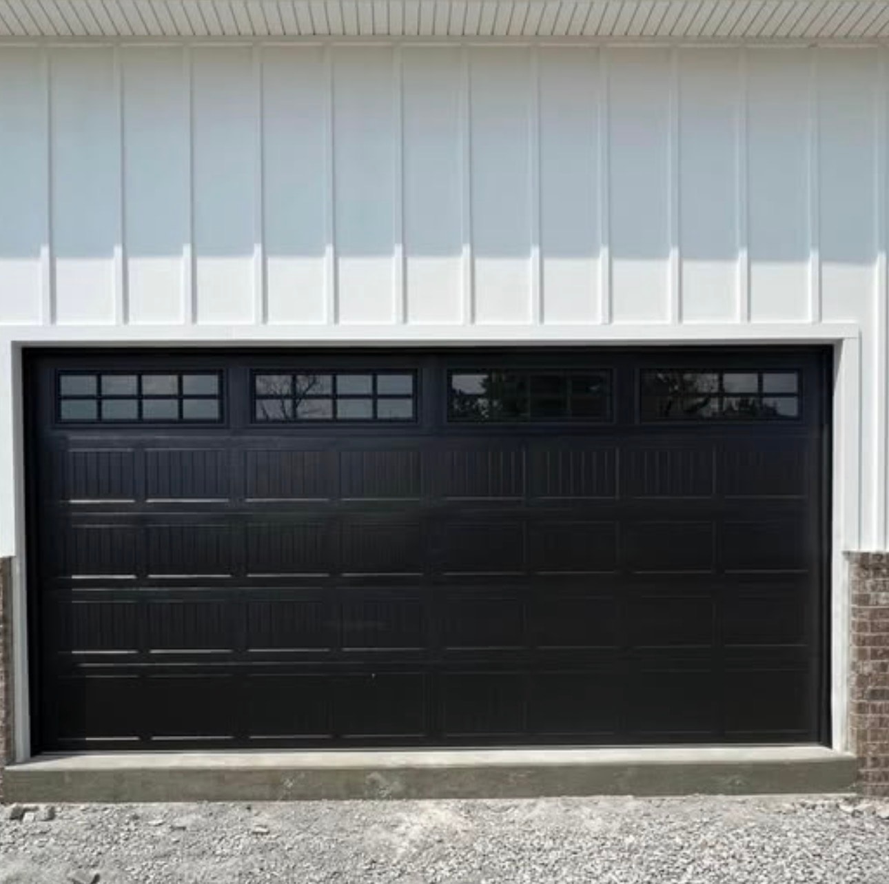 Black garage door modern white house